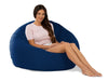 Woman sitting on a large navy bean bag chair against a white background