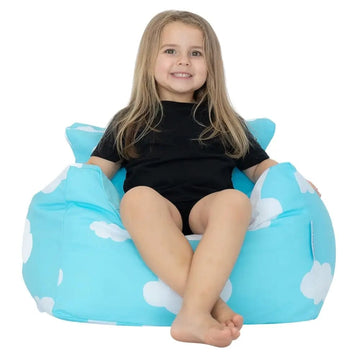 Child sitting in a blue cloud-patterned bean bag chair on a white background
